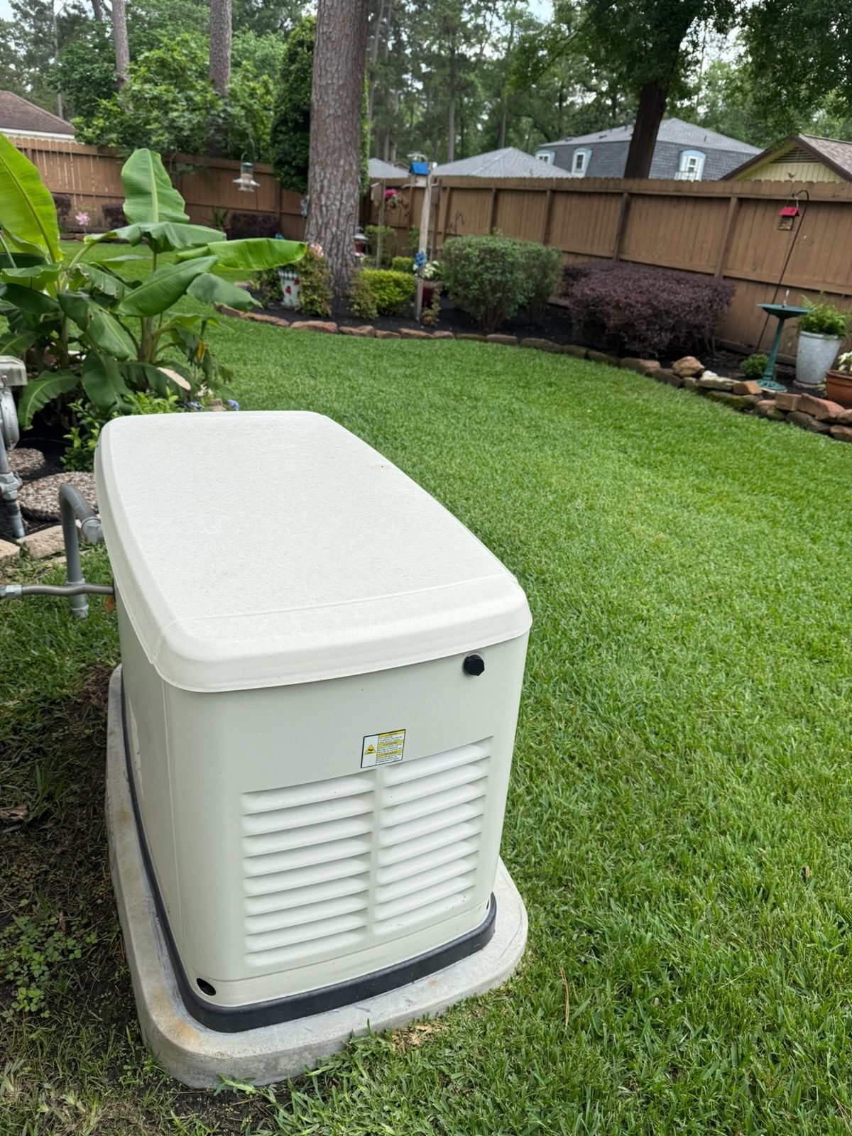 Finished Generac whole-home standby generator on a concrete pad in a Houston backyard, installed by VCG Electrical